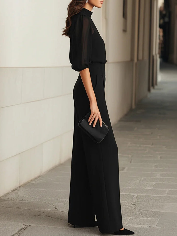 Iris | Conjunto de tres piezas en negro, compuesto por un top camisola transparente y unos pantalones de pierna ancha